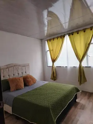 a bedroom with a bed and a window with yellow curtains at Squirrel and bird watching in Fresno