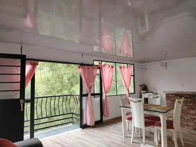 a dining room with a table and chairs and a balcony at Squirrel and bird watching in Fresno