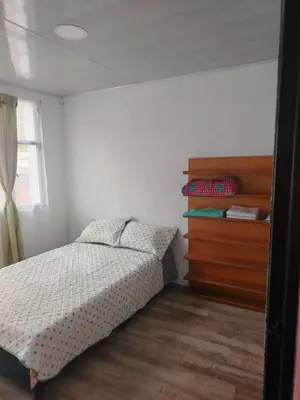 a bedroom with a bed and a dresser at Squirrel and bird watching in Fresno