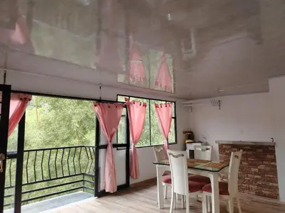 a dining room with a table and chairs and a balcony at Squirrel and bird watching in Fresno