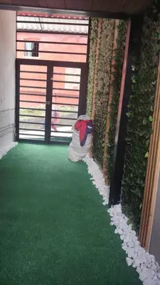 a garage with a green floor and a garage door with a bag at Squirrel and bird watching in Fresno