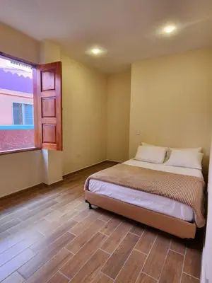 a bedroom with a bed and a window at Casa Colonial Jericó - Casa Romo in Jericó