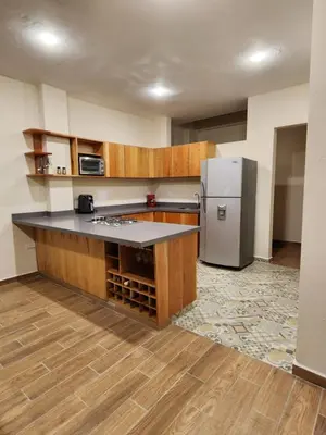 a kitchen with a counter and a refrigerator at Casa Colonial Jericó - Casa Romo in Jericó
