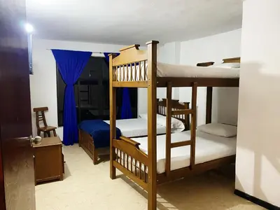 a bedroom with two bunk beds and a bed at Hotel Galería Plaza in Santa Bárbara