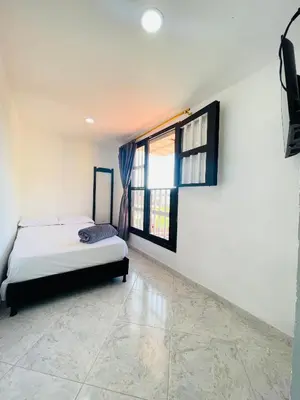 a bedroom with a bed and a window at Hospedaje Mi casita in Guatapé