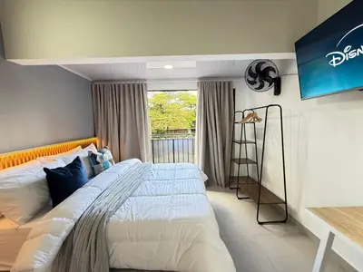a bedroom with a large bed and a window at Laureles Boutique Stay in Medellín