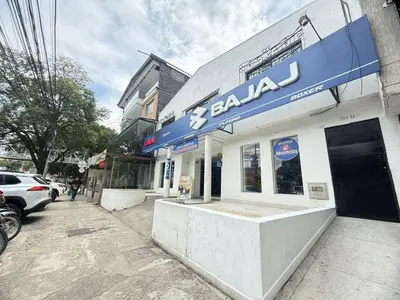 a store with a blue sign on the side of a building at Laureles Boutique Stay in Medellín
