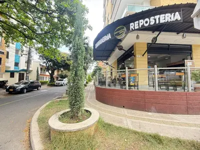 a tree in a pot in front of a restaurant at Laureles Boutique Stay in Medellín
