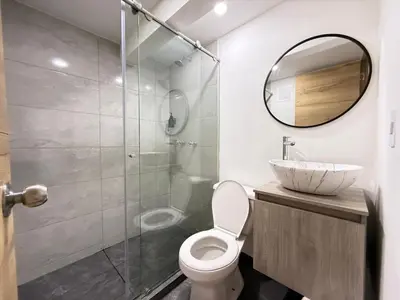 a bathroom with a sink and a toilet and a mirror at Laureles Boutique Stay in Medellín