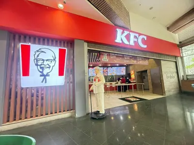 a man standing in front of a kfc store at Laureles Boutique Stay in Medellín