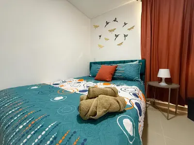 a bedroom with a stuffed animal laying on a bed at Apartamento con vista a la montaña, piscina y gym in Sabaneta