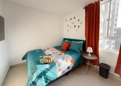 a bedroom with a bed with a teddy bear on it at Apartamento con vista a la montaña, piscina y gym in Sabaneta