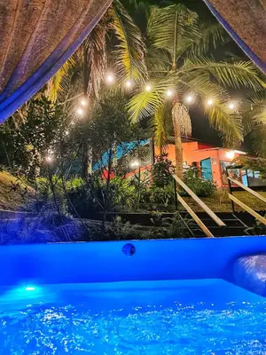 a view of a swimming pool at night at Hotel Marrokos Aeropuerto José María Córdova in Rionegro