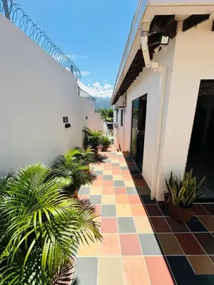 a courtyard of a house with a tiled floor and plants at Hotel Paraiso Cañaveral in Santa Fe de Antioquia