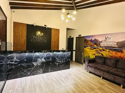 a lobby with a stage and a couch in a room at Hotel Paraiso Cañaveral in Santa Fe de Antioquia