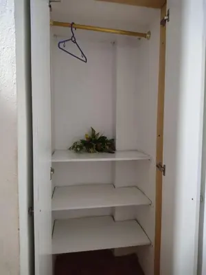 a closet with white shelves in a room at Hospedaje Bonanza in Santa Fe de Antioquia