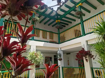 a building with a ceiling with plants and flowers at Hotel Vegas del Rio in Támesis