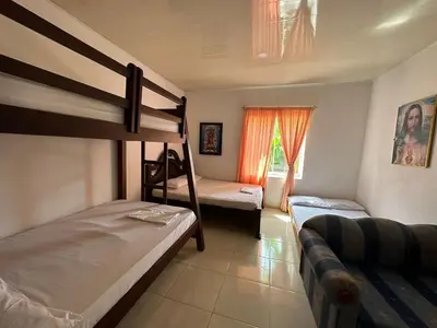 a bedroom with two bunk beds and a couch at Casa Finca La Magdalena Pool and Warm Climate in Sopetran