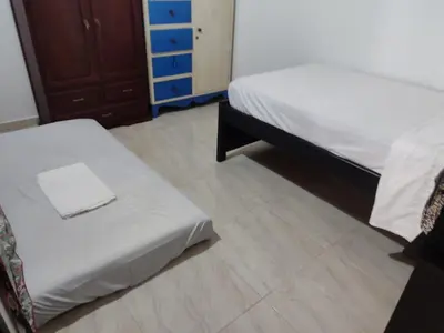 a bedroom with two beds and a wooden floor at Casa Finca La Magdalena Pool and Warm Climate in Sopetran