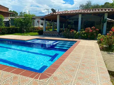 a swimming pool in front of a house at Casa Finca La Magdalena Pool and Warm Climate in Sopetran
