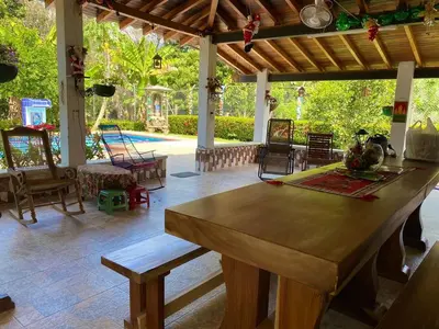 a living room with a large wooden table and chairs at Casa Finca La Magdalena Pool and Warm Climate in Sopetran