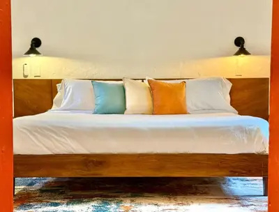 a bed with many pillows on top of it at Elegant Colonial Walkable Casa in Jericó