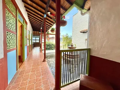 a porch of a house with a balcony at Elegant Colonial Walkable Casa in Jericó
