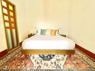 a bedroom with a white bed and a window at Elegant Colonial Walkable Casa in Jericó