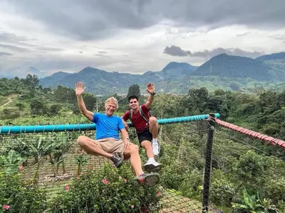 two people sitting on a monkey bar on a mountain at Apartamento Privado en el Centro, Programación de Tours y Mas in Jardin