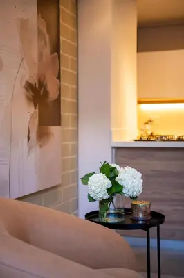 a table with a vase of white flowers on it at 99Rentall in Medellín