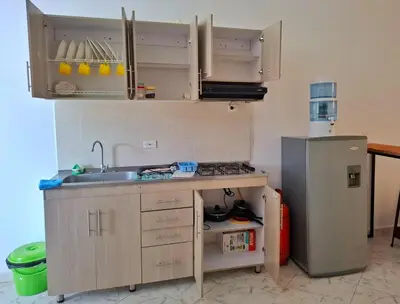 a small kitchen with a sink and a refrigerator at OSIMiRI CUERVOS in San Rafael