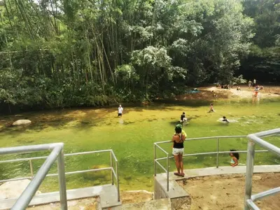 a group of people swimming in a body of water at OSIMiRI CUERVOS in San Rafael