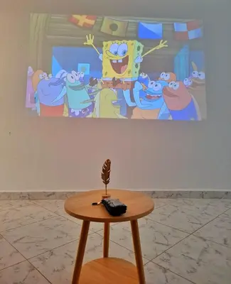 a table in front of a painting of a cartoon at OSIMiRI CUERVOS in San Rafael