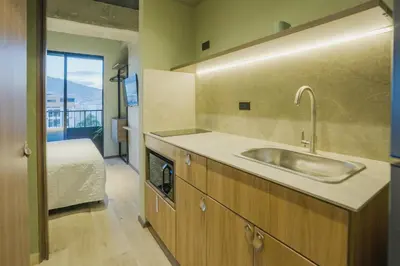 a kitchen with a sink and a bed in a room at BRENT 30 Living in Medellín