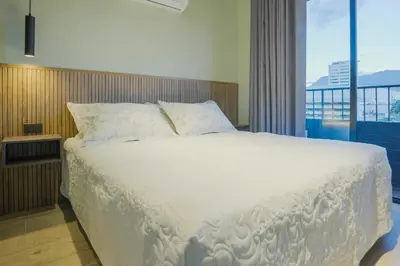 a bedroom with a white bed with a large window at BRENT 30 Living in Medellín