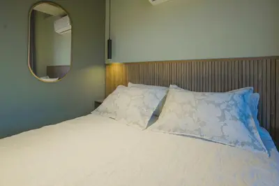 a bedroom with a white bed with a mirror at BRENT 30 Living in Medellín