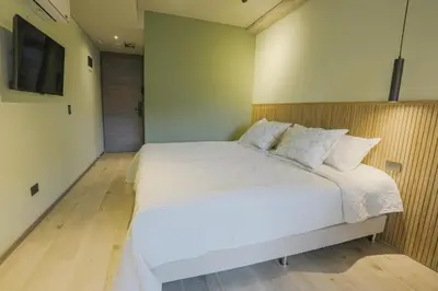 a bedroom with a large white bed in a room at BRENT 30 Living in Medellín