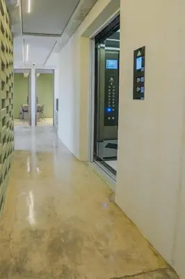an empty hallway in an office building with a window at BRENT 30 Living in Medellín