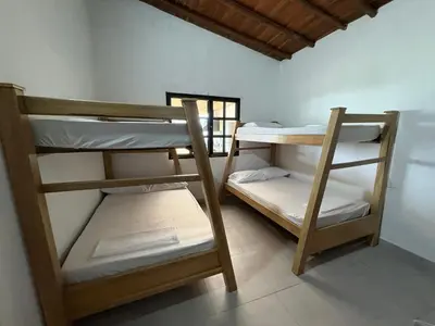 two bunk beds in a room with a window at Finca, piscina y sin limite de sonido en Sopetran in Sopetran