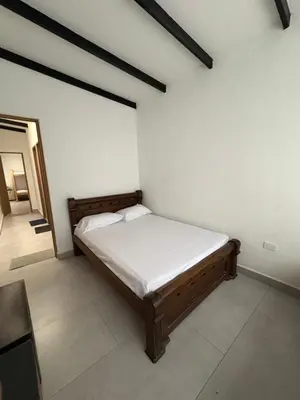 a bedroom with a bed in the corner of a room at Finca, piscina y sin limite de sonido en Sopetran in Sopetran