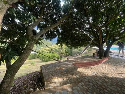 a hammock hanging from a tree in a park at Finca, piscina y sin limite de sonido en Sopetran in Sopetran