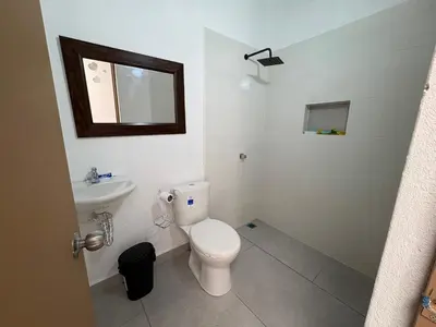 a white bathroom with a toilet and a sink at Finca, piscina y sin limite de sonido en Sopetran in Sopetran