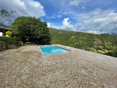 a swimming pool in the middle of a stone patio at Finca, piscina y sin limite de sonido en Sopetran in Sopetran