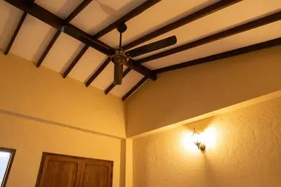 a ceiling fan in a room with a door at Hotel Boutique Lomas Colonial in Santa Fe de Antioquia