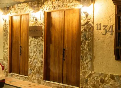 a pair of wooden doors on a stone wall at Hotel Boutique Lomas Colonial in Santa Fe de Antioquia