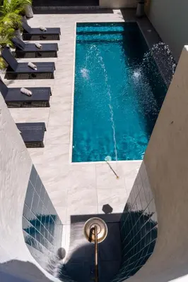 a swimming pool with stairs next to a swimming pool at Hotel Boutique Lomas Colonial in Santa Fe de Antioquia