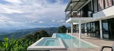 a house with a swimming pool and mountains in the background at Don Café - Luxury and confort in Manizales