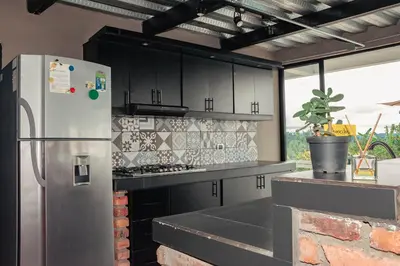 a kitchen with a stainless steel refrigerator and a counter at Don Café - Luxury and confort in Manizales