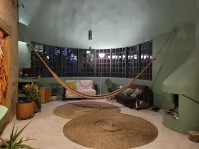 a room with a hammock in the middle of a room at Casa Rosa de los Vientos in oak forest in Medellín