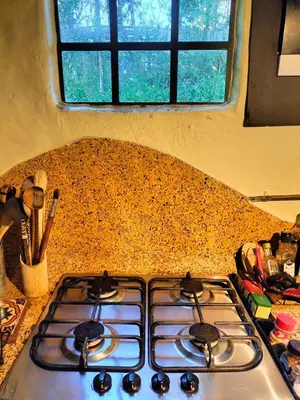 a stove top in a kitchen with a window at Casa Rosa de los Vientos in oak forest in Medellín